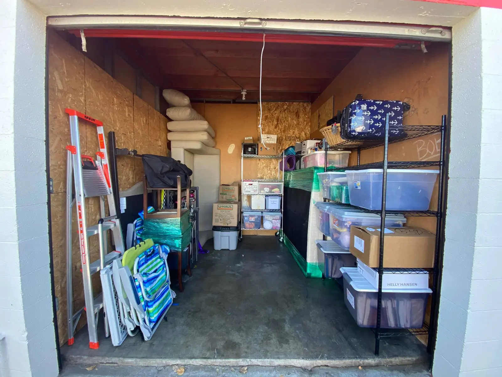 Storage unit organized with shelving and labeled bins