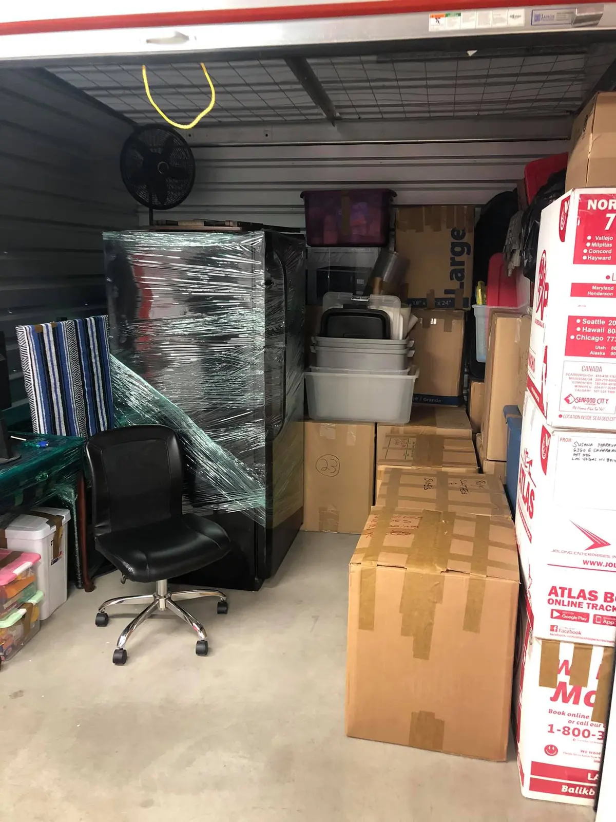Storage unit loaded floor to ceiling with careful stacking